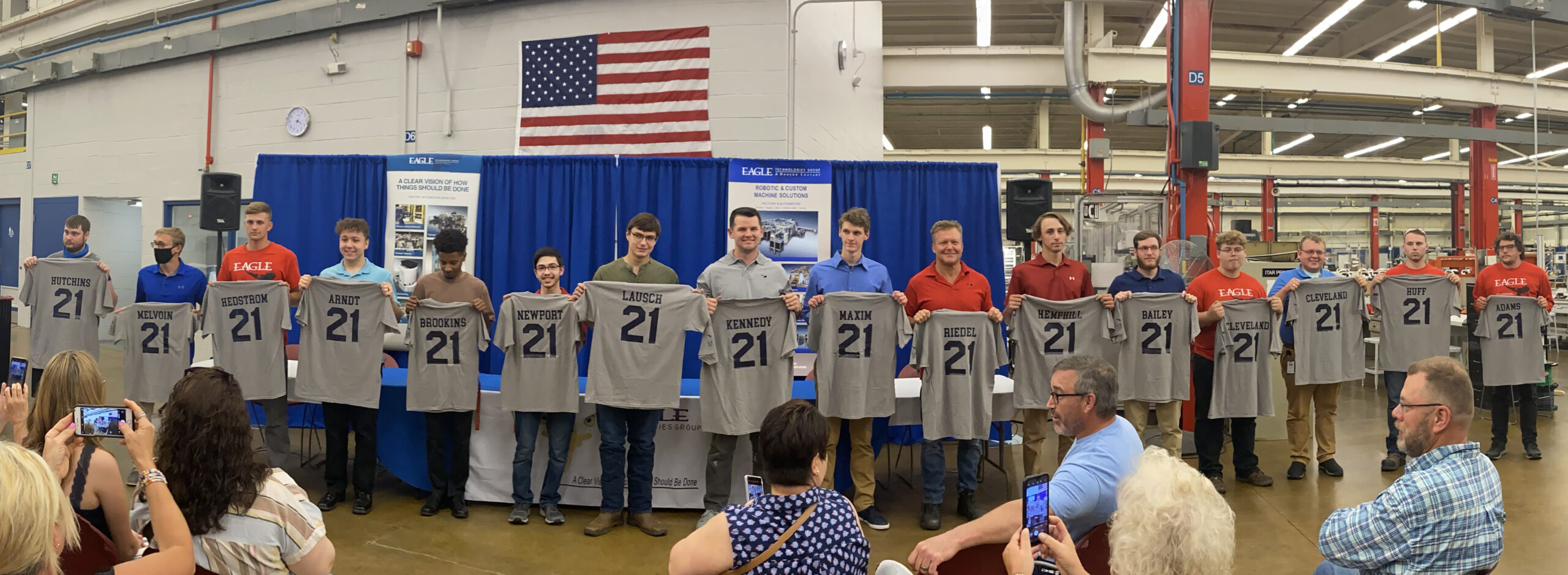 participants in the Eagle’s apprenticeship program holding their customized T-shirts